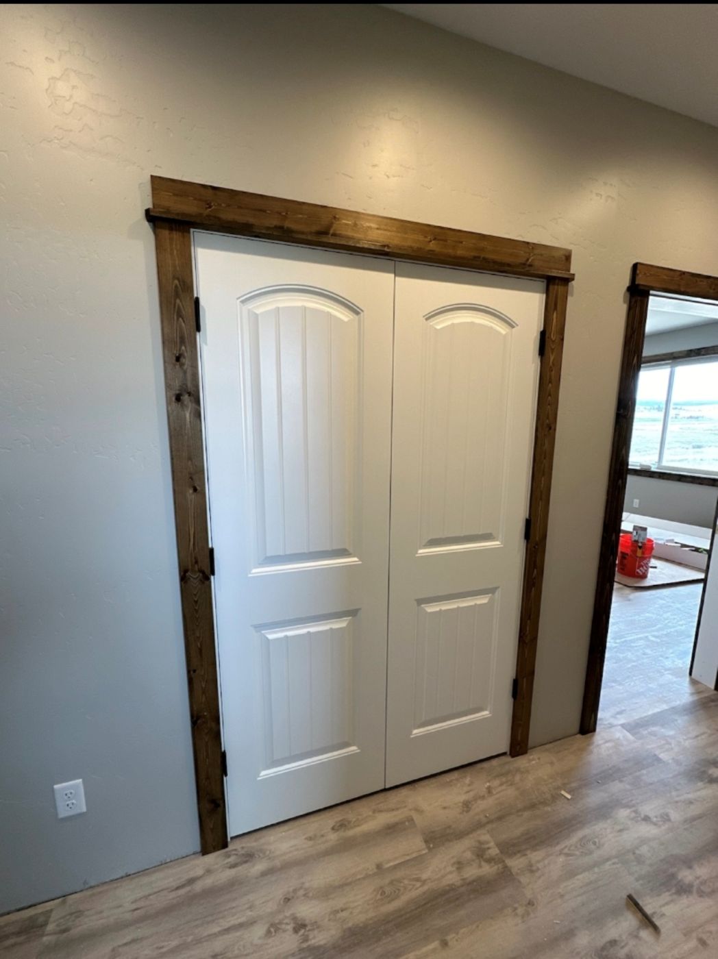 New closet doors with dark wood trim